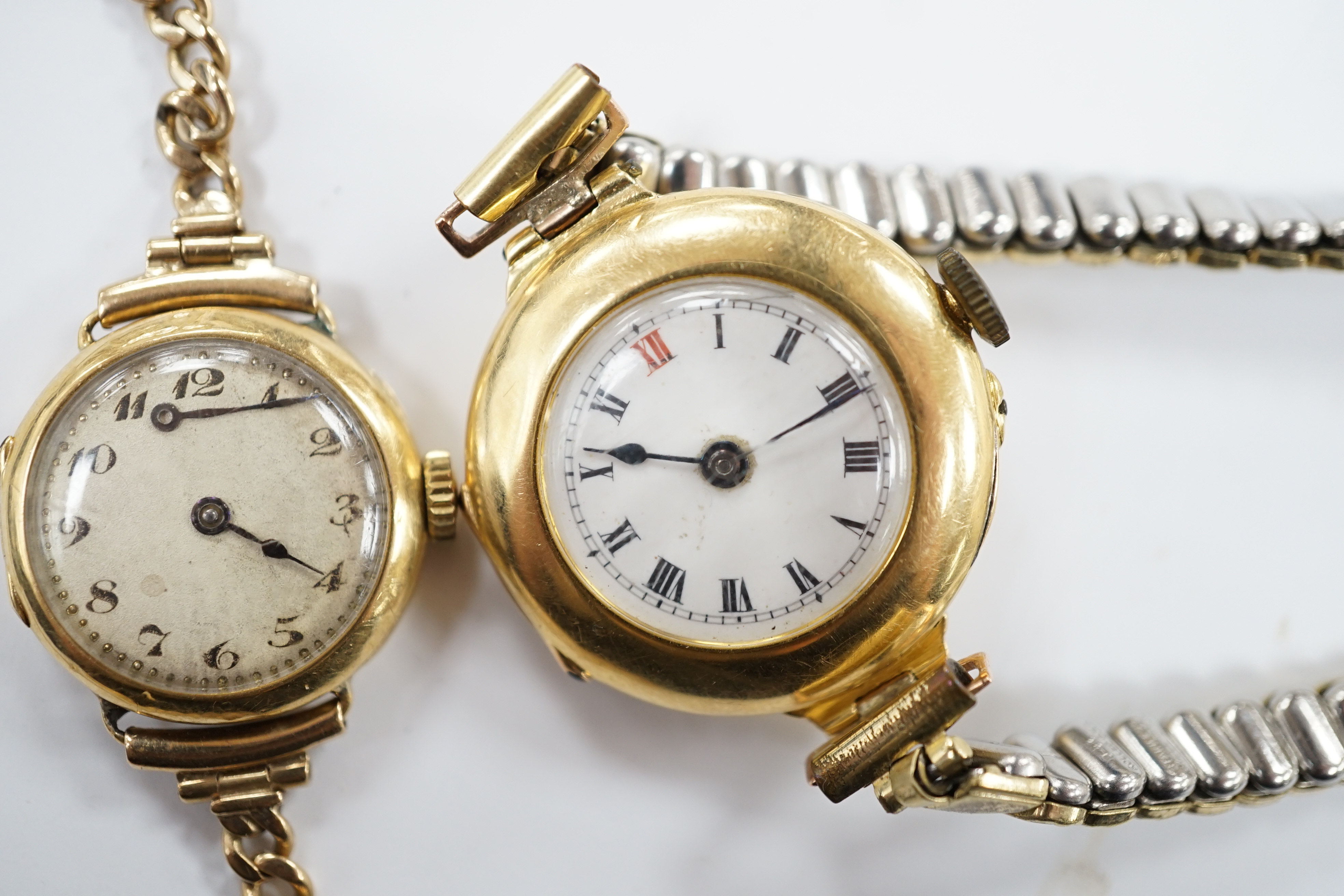 A lady's early to mid 20th century 18ct gold manual wind wrist watch on a 9ct bracelet, together with one other similar 18ct gold manual wrist watch, on a flexible gold plated flexible bracelet.